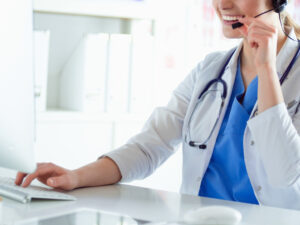 Young,Practitioner,Doctor,Working,At,The,Clinic,Reception,Desk,,She